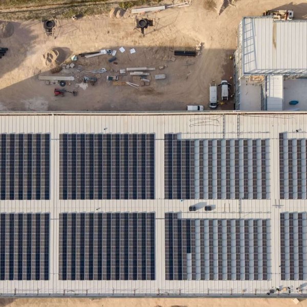 Aerial shot large cladded building solar panels